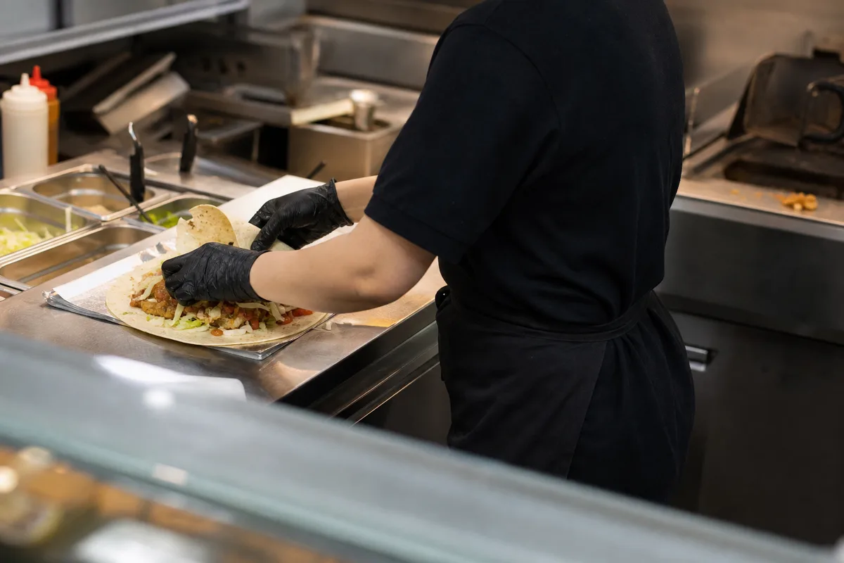 Équipier de restauration rapide préparant une commande au comptoir